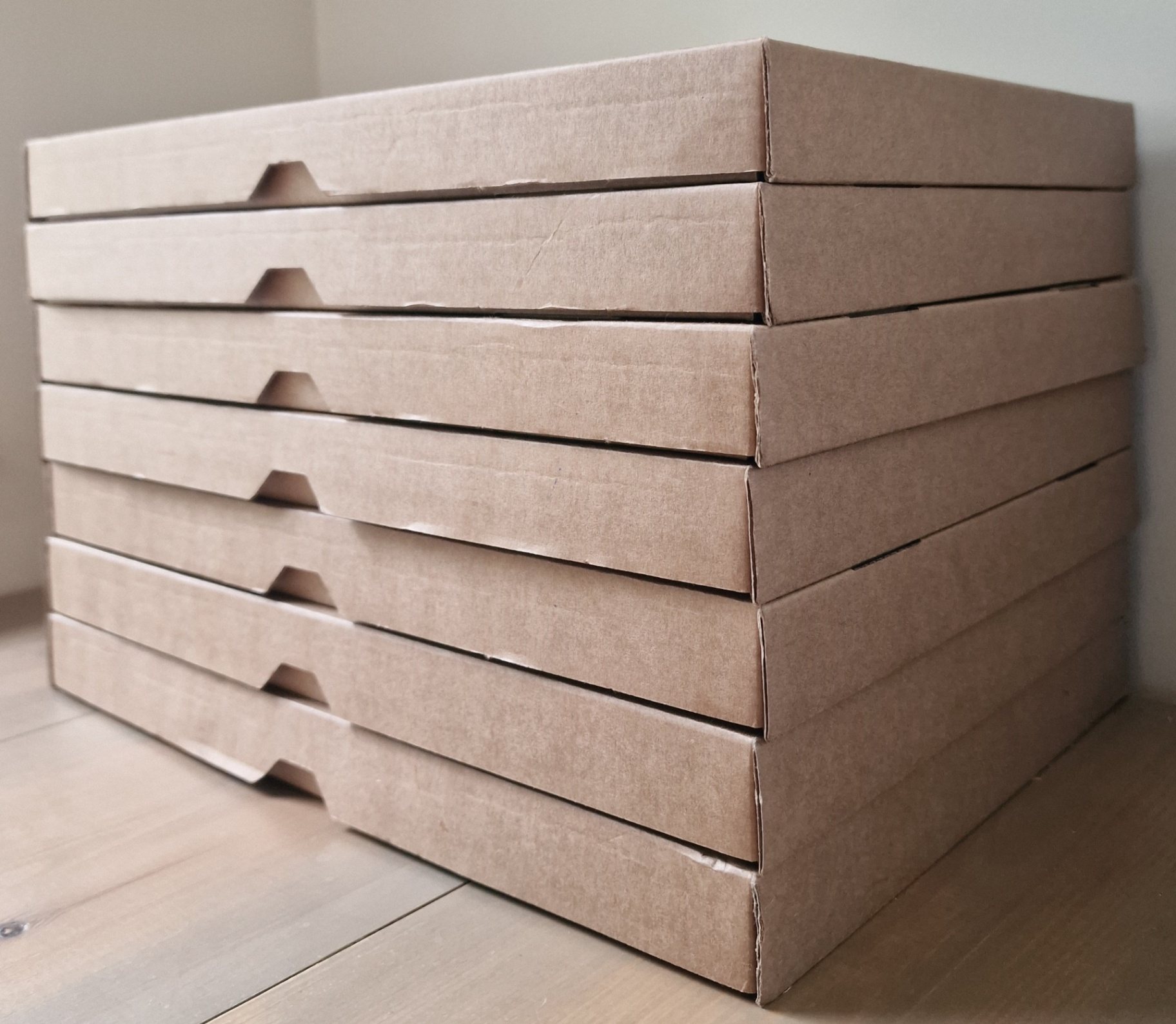 Stack of cardboard boxes with wooden grooves